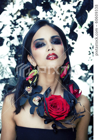 pretty brunette woman with rose jewelry, black and red, bright make up kike a vampire closeup red lips pretty brunette woman with rose jewelry, black and red, bright make up kike a vampire closeup red lips 60609338