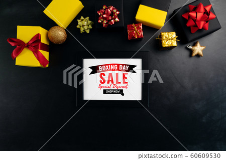Boxing day sale with Christmas present and xmas decoration on black background Boxing day sale with Christmas present and xmas decoration on black background 60609530