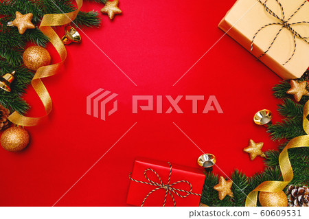 Christmas present and pine tree with xmas decoration on Red background Christmas present and pine tree with xmas decoration on Red background 60609531