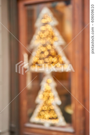 Abstract blur. Street in a Christmas day in an old European town. Lamps garlands, christmas decor and decorations. The decoration of the shop window or restaurant. Abstract blur. Street in a Christmas day in an old European town. Lamps garlands, christmas decor and decorations. The decoration of the shop window or restaurant. 60609610