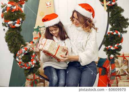 Mother with cute daughter in a christmas decorations Mother with cute daughter in a christmas decorations 60609970