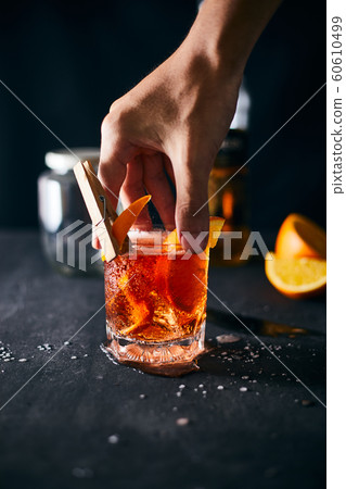 Alcoholic cocktail with orange peel and ice.. Alcoholic cocktail with orange peel and ice.. 60610499