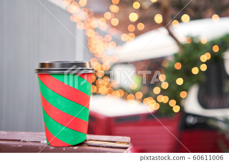Red and green Christmas Cup with mulled wine. Christmas Market in European small city. 60611006
