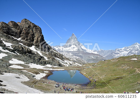 Upside down Matterhorn and Riffelhorn reflected in Riffel Lake Upside down Matterhorn and Riffelhorn reflected in Riffel Lake 60611235