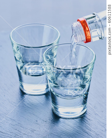alcohol is poured into glasses 60611588
