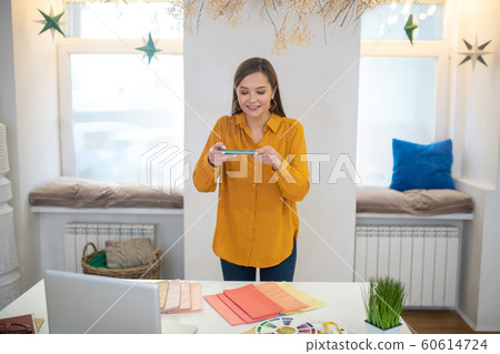 Attractive young woman standing at the desk Attractive young woman standing at the desk 60614724