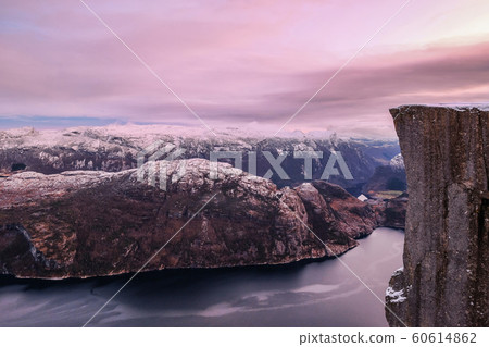 The famous Preikestolen Pulpit Rock over the Lysefjord, beautiful colors at sunset, Ryfylke, Rogaland, Norway The famous Preikestolen Pulpit Rock over the Lysefjord, beautiful colors at sunset, Ryfylke, Rogaland, Norway 60614862