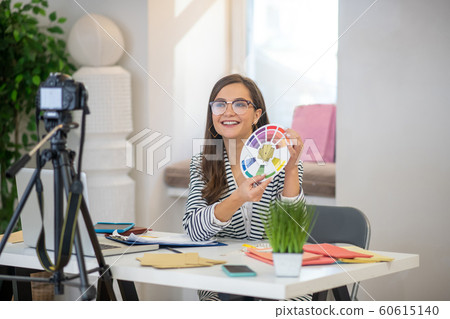 Joyful good looking woman speaking on camera 60615140