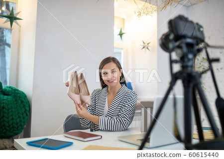 Young brunette woman presenting very beautiful shoes 60615440