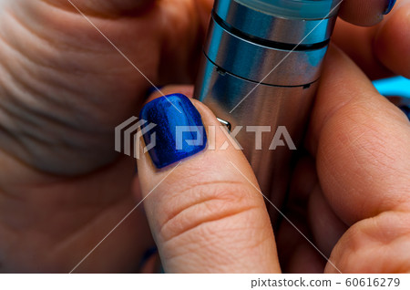 Close-up - female hands preparing device to vaping e-cigarette. Close-up - female hands preparing device to vaping e-cigarette. 60616279