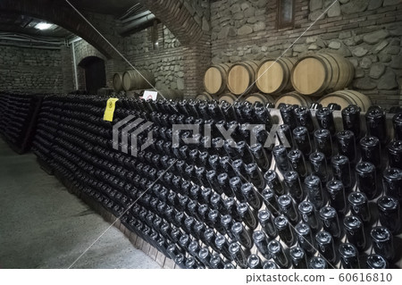 Ancient wine cellar with oak barrels and shelves Ancient wine cellar with oak barrels and shelves 60616810