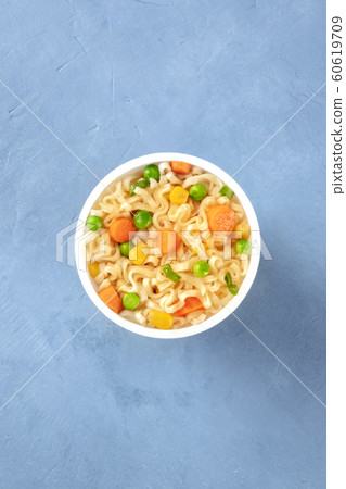 Ramen cup, instant soba noodles with vegetables in a plastic cup, overhead shot with copy space 60619709
