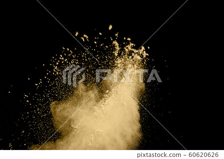 Golden powder explosion on black background. Golden powder explosion on black background. 60620626