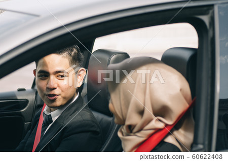 couple of young executive siiting in a car couple of young executive siiting in a car 60622408