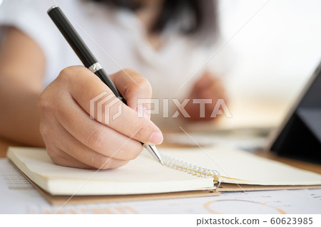 Close shot of businesswoman hands holding a pen Close shot of businesswoman hands holding a pen 60623985