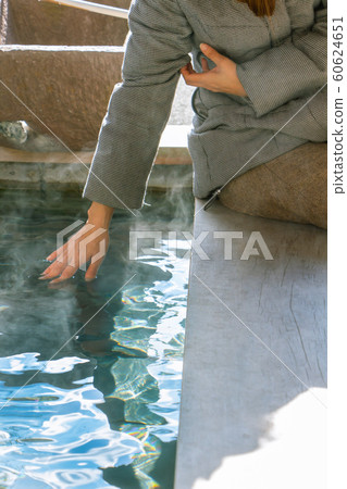 A woman looking at the hot spring bath A woman sitting on a footbath 60624651