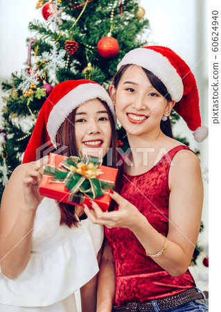 Two Asian girls teen in happiness Christmas New Year Eve Gift Two Asian girls teen in happiness Christmas New Year Eve Gift 60624940