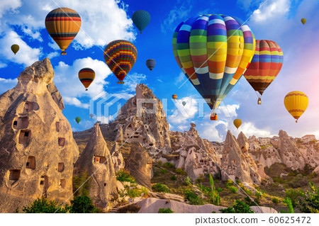 Colorful hot air balloon flying over Cappadocia, Turkey. 60625472