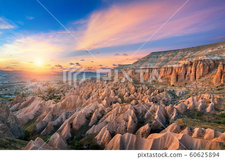 Beautiful mountains and Red valley at sunset in Goreme, Cappadocia in Turkey. Beautiful mountains and Red valley at sunset in Goreme, Cappadocia in Turkey. 60625894