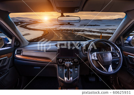 Looking through a car windshield with sunset and road in winter. Travel in car. Looking through a car windshield with sunset and road in winter. Travel in car. 60625931