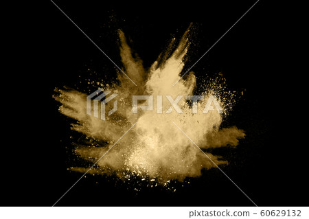 Golden powder explosion on black background. 60629132