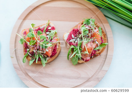 Tasty italian bruschetta on the wooden plate Tasty italian bruschetta on the wooden plate 60629599