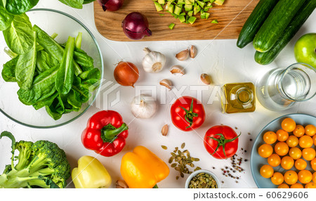 different vegetables for cooking salad on the table. Healthy diet concept. Top view. different vegetables for cooking salad on the table. Healthy diet concept. Top view. 60629606