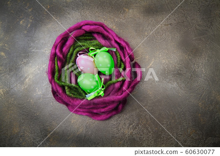 Wooden nest with Easter eggs on dark background Wooden nest with Easter eggs on dark background 60630077