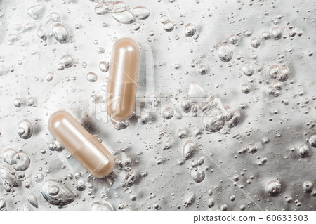 Beauty capsule on backdrop with cosmetic oxygen bubbles 60633303