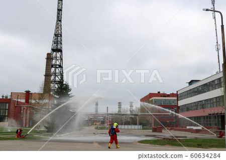 Professional firefighters in orange fire- 60634284