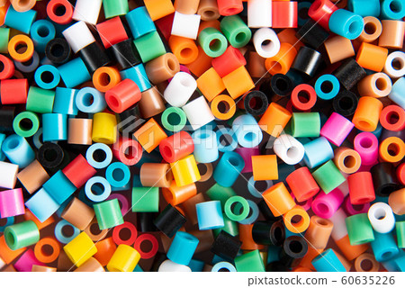 Set of multicolor fusible perler beads close up, top view. Kids toy that develops the imagination of child. Theme of leisure, hobby and development Set of multicolor fusible perler beads close up, top view. Kids toy that develops the imagination of child. Theme of leisure, hobby and development 60635226