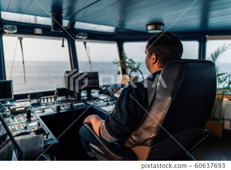Marine navigational officer during navigational watch on Bridge . Work at sea 60637693