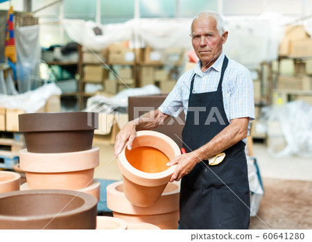 Man choosing pots for plants Man choosing pots for plants 60641280