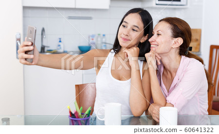 Mother and daughter making selfie Mother and daughter making selfie 60641322