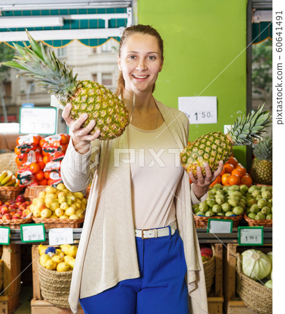 Portrait of woman who is demonstraiting pineapples 60641491
