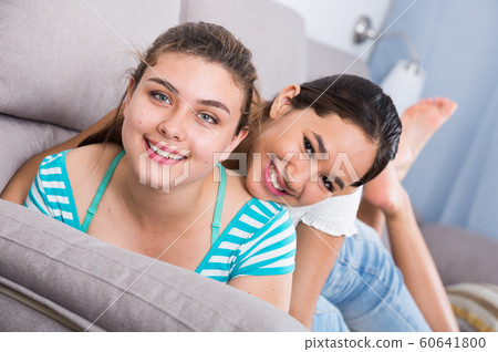 Two cheerful teenagers girls on sofa Two cheerful teenagers girls on sofa 60641800