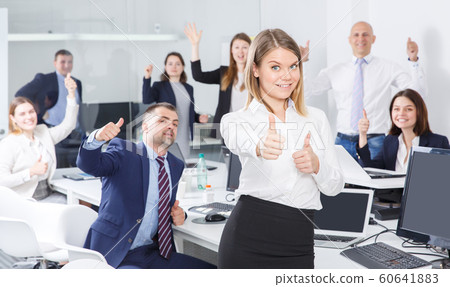 Woman with adult team celebrating victory 60641883