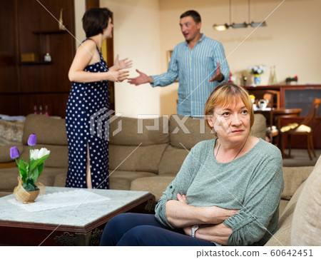 Unhappy senior woman sitting, emotional woman quarrel with man Unhappy senior woman sitting, emotional woman quarrel with man 60642451