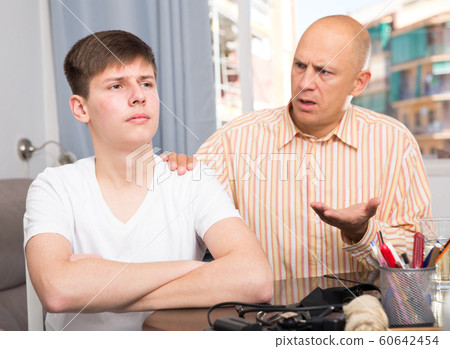 Man scolding son at home Man scolding son at home 60642454