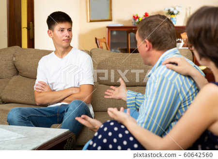 Male and female quarrelling with their son 60642560