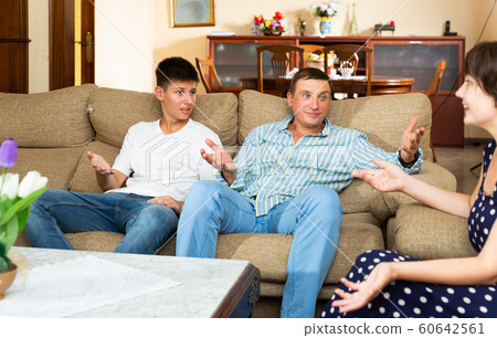 Friendly family of three talking 60642561