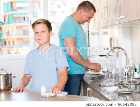Man with his son are washing dishes on the kitchen Man with his son are washing dishes on the kitchen 60642888