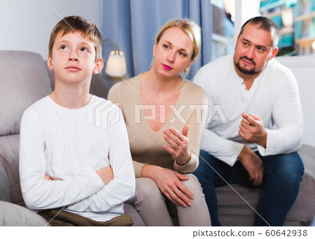 Upset boy scolded by parents Upset boy scolded by parents 60642938