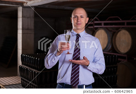 Winemaker inviting to wine degustation Winemaker inviting to wine degustation 60642965