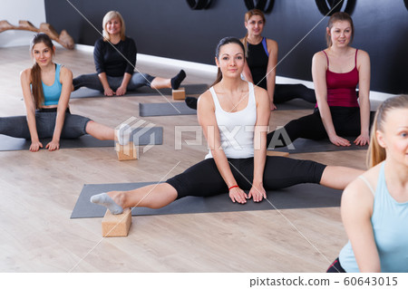 Females exercising during yoga class Females exercising during yoga class 60643015