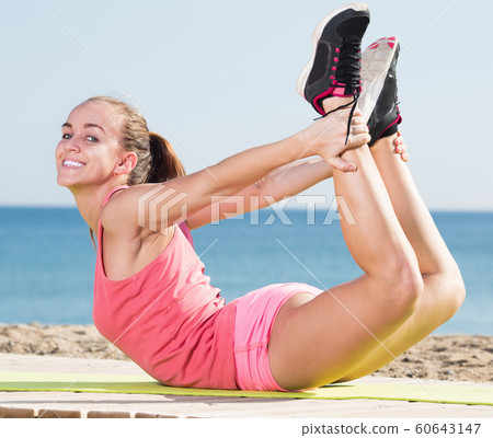 Happy girl in sportswear training at sea beach Happy girl in sportswear training at sea beach 60643147