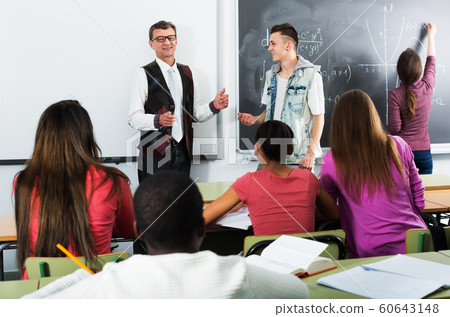 Students and teacher in class Students and teacher in class 60643148