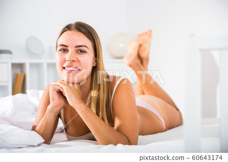 Woman in lingerie lying in bed Woman in lingerie lying in bed 60643174