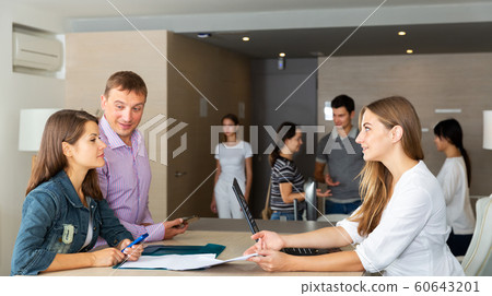 Male and female managers having meeting Male and female managers having meeting 60643201