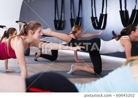 Females exercising during yoga class 60643202